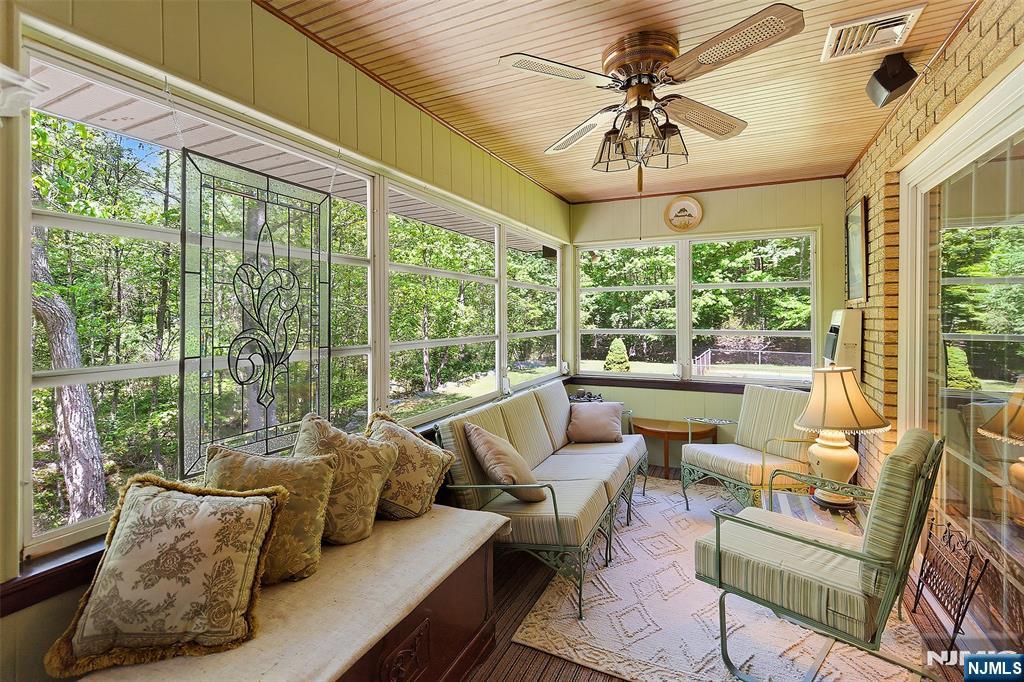 Bright Enclosed 4 season Sun Porch w heat. The perfect place to read and have coffee.