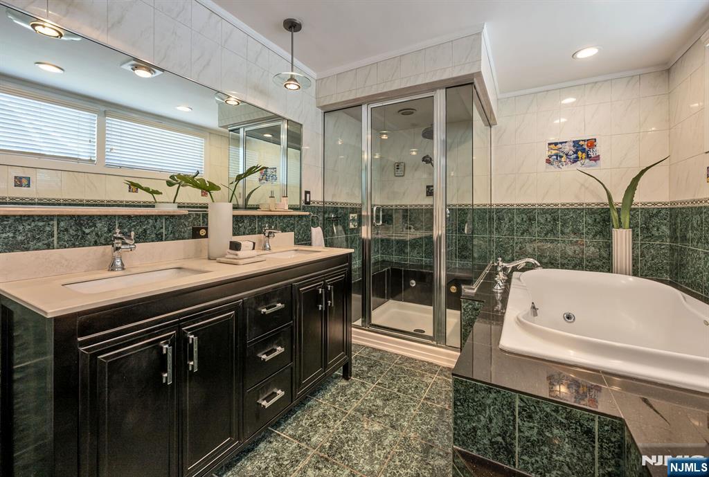 Primary Bathroom with Glass Enclosed Shower and a Jetted Tub