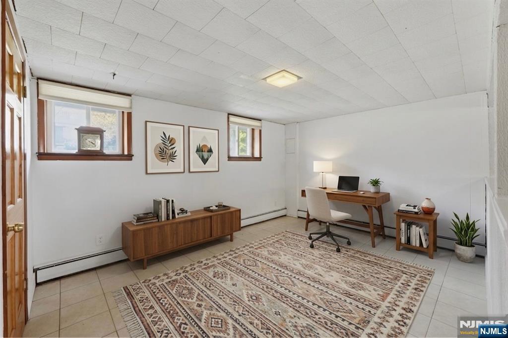 The lower level offers exceptional flexibility with expansive bonus living space, an additional kitchen area, full bath, and private rooms ideal for extended living