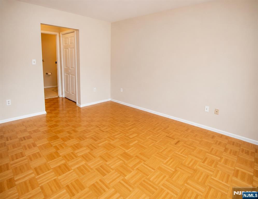 Primary bedroom, looking towards en suite bath, furniture virtually removed & parquet floor added
