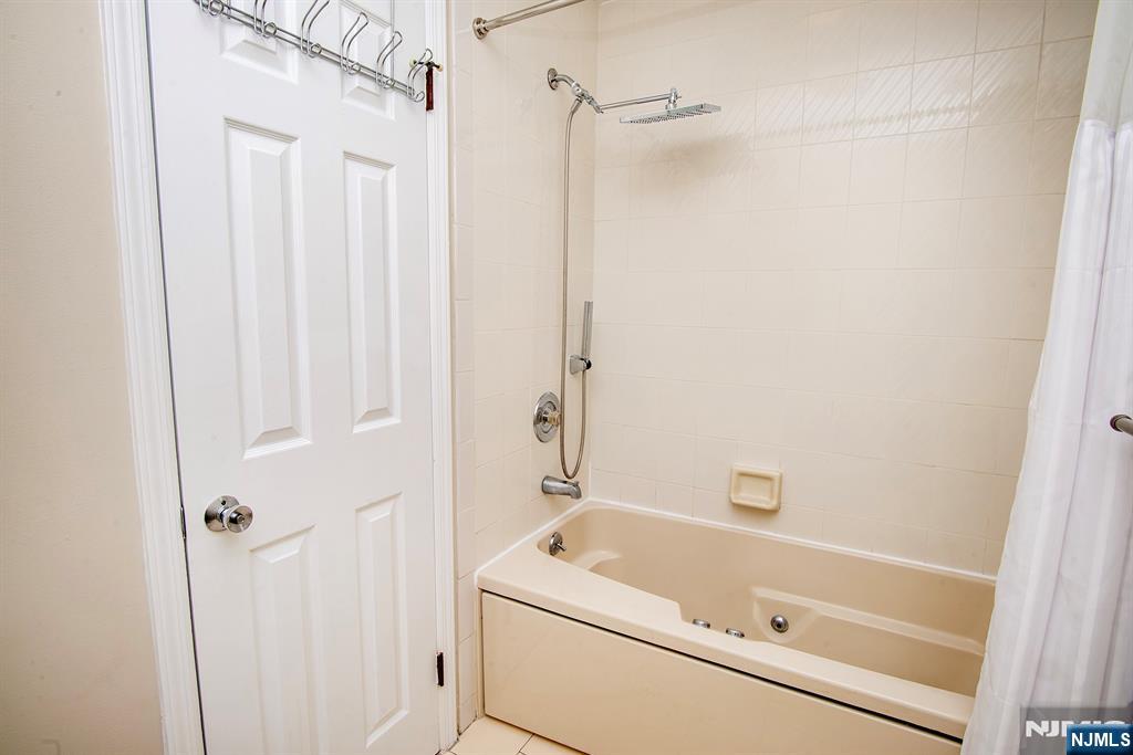 en suite bath with Whirlpool tub and rain shower