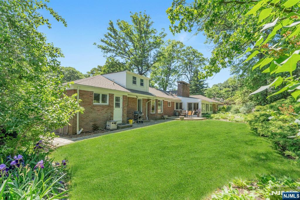 back lawn made for soccer games, cartwheels, and barefoot daydreaming. Set on .69 acres, it's a backyard built for everyone. Sprinkler system keeps it all green all summer long.