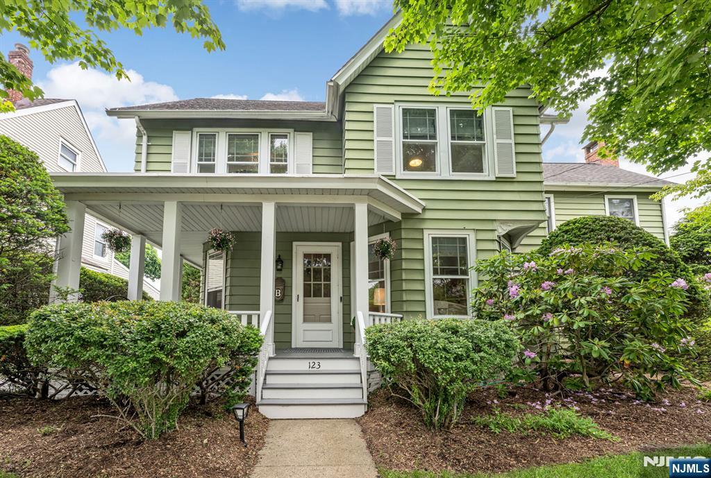 Ideally located close to town, schools, restaurants, and transportation, this stunning Colonial perfectly blends timeless charm with modern updates. Gleaming new hardwood floors run throughout the home, while the inviting open floor plan offers both everyday comfort and effortless entertaining. The welcoming entrance foyer flows into a charming living room with fireplace, banquet-sized formal dining room, and an incredible light-filled family room featuring new custom built-ins, a beautiful fireplace, and French doors opening to an oversized deck. The spacious kitchen with island opens seamlessly to an expansive breakfast room surrounded by windows, creating the perfect gathering space. A powder room and exceptional mudroom complete the first floor. The second floor offers two spacious sun-filled bedrooms, a full hall bath, a serene third bedroom or office, and a luxurious primary suite with an updated spa-like shower bath. The third floor provides wonderful flexibility with an additional bedroom featuring skylights, office space, and a walk-in closet. The partially finished lower level includes a playroom, laundry area, and abundant storage. Outside, the beautifully landscaped backyard is ideal for entertaining, relaxing, and play. This exceptional home truly has it all.
